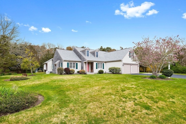 cape cod-style house with a garage and a front yard