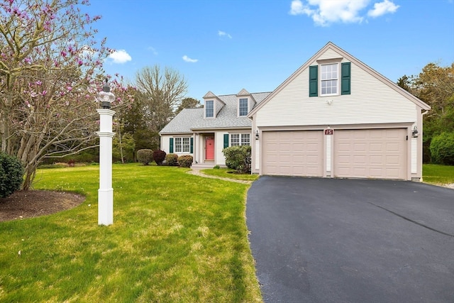 view of front of house with a garage and a front lawn