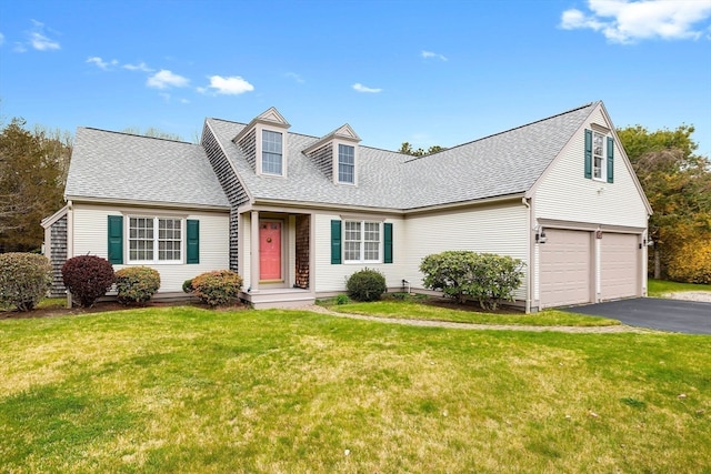 cape cod home featuring a garage and a front yard