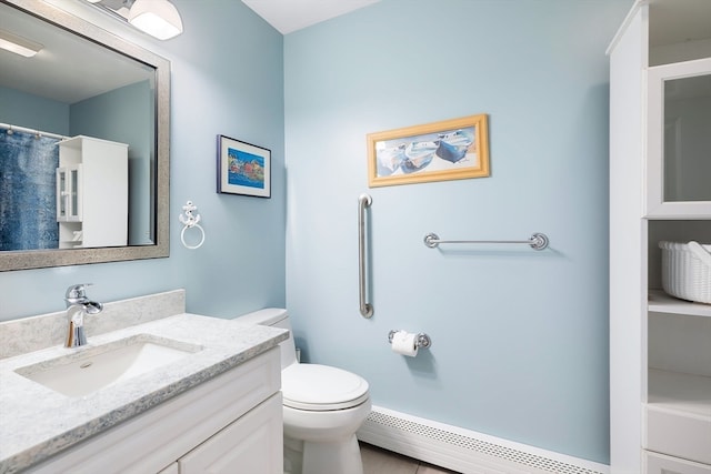 bathroom with baseboard heating, toilet, and large vanity