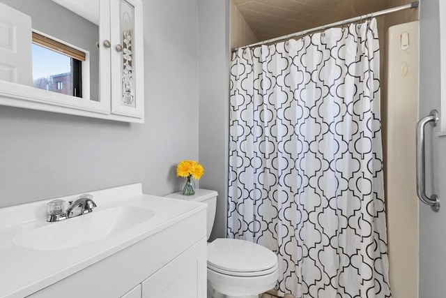 bathroom featuring vanity, a shower with shower curtain, and toilet