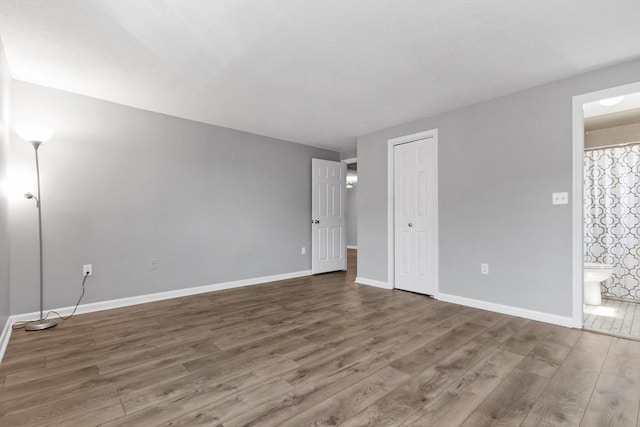 interior space with baseboards and wood finished floors