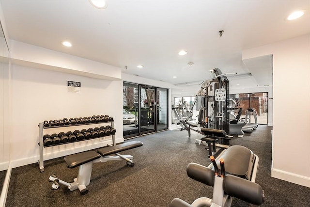 exercise room with recessed lighting and baseboards