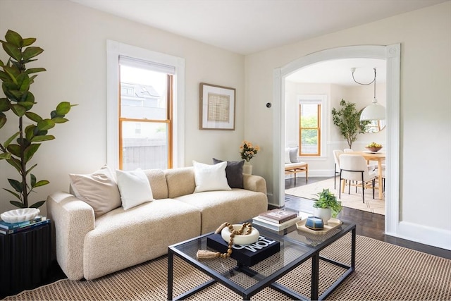 36 Warwick St, Somerville, MA 02145 - living room with arched walkways, wood finished floors, and baseboards