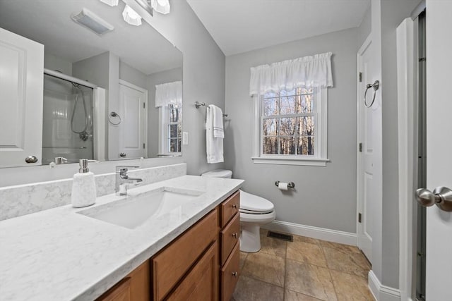 bathroom featuring vanity, toilet, and a shower with shower door