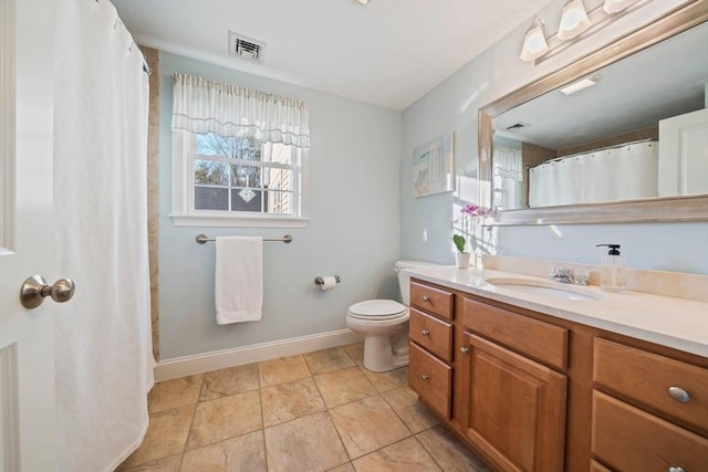 bathroom featuring vanity, tile patterned floors, and toilet