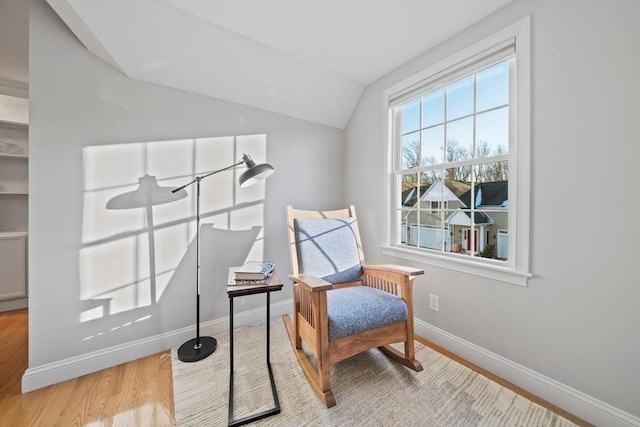 sitting room with vaulted ceiling and light hardwood / wood-style floors