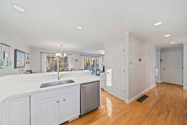 kitchen featuring decorative light fixtures, white cabinetry, sink, ornamental molding, and stainless steel dishwasher