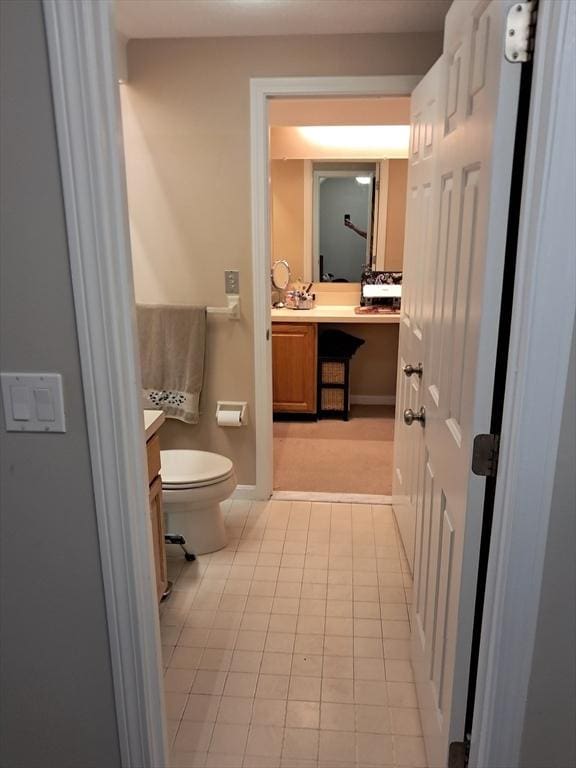 3901 Woodbridge Rd Unit 3901, Peabody, MA 01960 - bathroom featuring vanity, toilet, baseboards, and tile patterned flooring