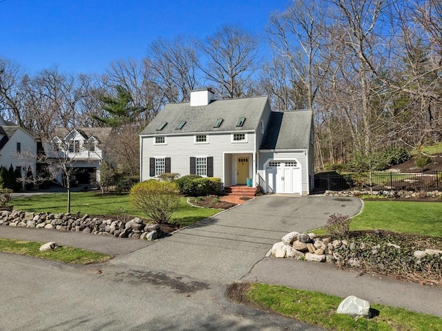 cape cod-style house with a chimney, a front lawn, aphalt driveway, a garage, and fence