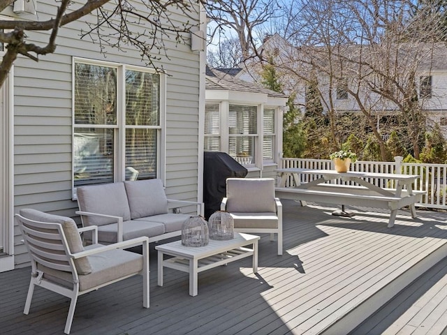 wooden deck featuring an outdoor living space and grilling area