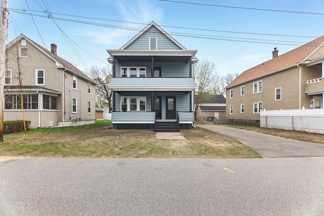 view of front of property with a porch and fence