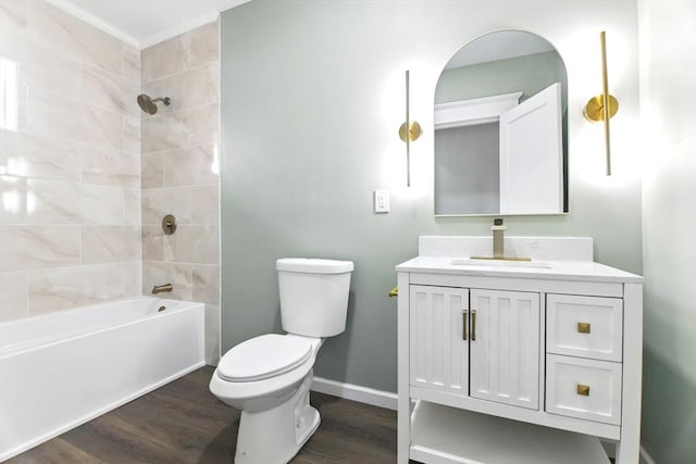 full bathroom with toilet, wood finished floors, vanity, shower / bath combination, and baseboards
