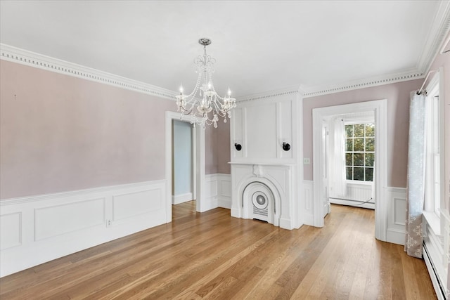 unfurnished living room with light hardwood / wood-style flooring, ornamental molding, and a baseboard heating unit