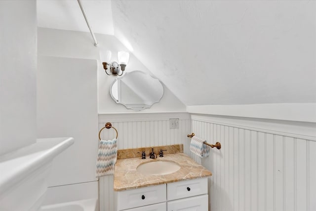 bathroom with vanity and vaulted ceiling