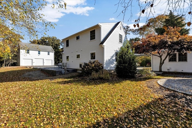 rear view of property featuring a patio area and a yard