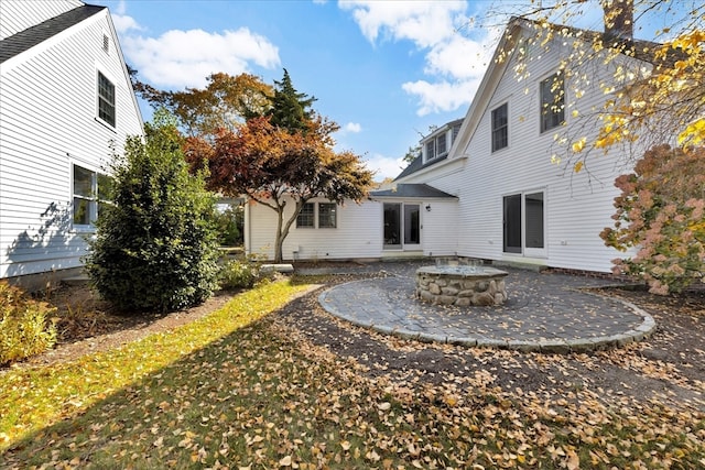 exterior space with an outdoor fire pit and a patio