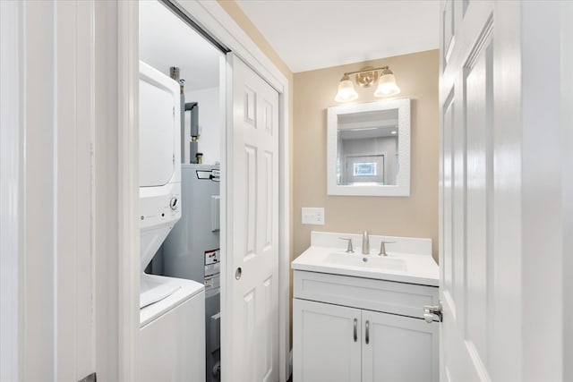 laundry room with sink and stacked washer and dryer