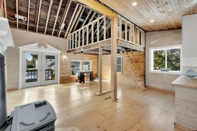 interior space with wood ceiling, high vaulted ceiling, wood-type flooring, wood walls, and french doors