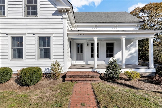 view of exterior entry with covered porch