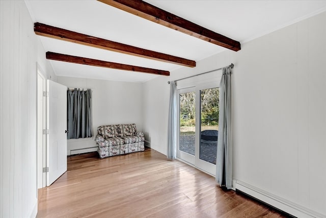 unfurnished room with beamed ceiling, a baseboard heating unit, light hardwood / wood-style floors, and wood walls