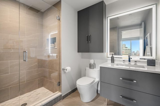 full bath featuring vanity, toilet, a shower stall, and tile patterned flooring