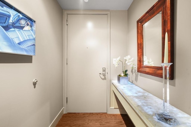 interior space featuring baseboards and wood finished floors