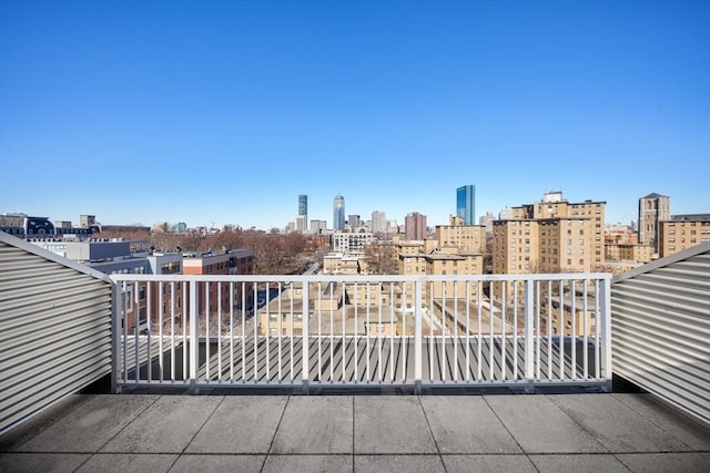 view of patio / terrace featuring a view of city and a balcony