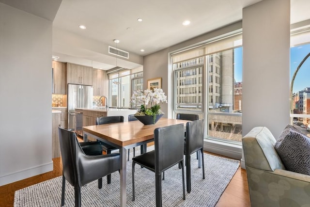 dining area with visible vents, recessed lighting, and light wood-type flooring