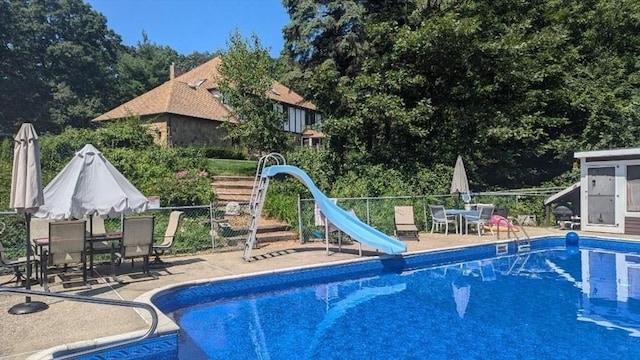 23 Carr Rd, Berlin, MA 01503 - view of swimming pool with a water slide, outdoor dining area, a patio area, and fence
