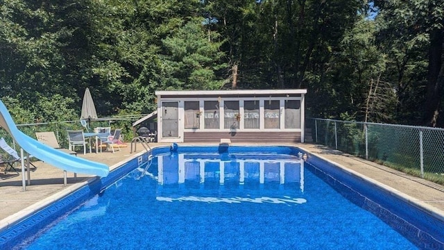 23 Carr Rd, Berlin, MA 01503 - view of swimming pool with a water slide, fence, and an outbuilding