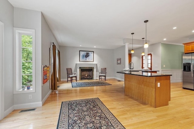 10 Londonderry Ln, Georgetown, MA 01833 - kitchen with stainless steel refrigerator with ice dispenser, open floor plan, light wood-style flooring, a peninsula, and pendant lighting