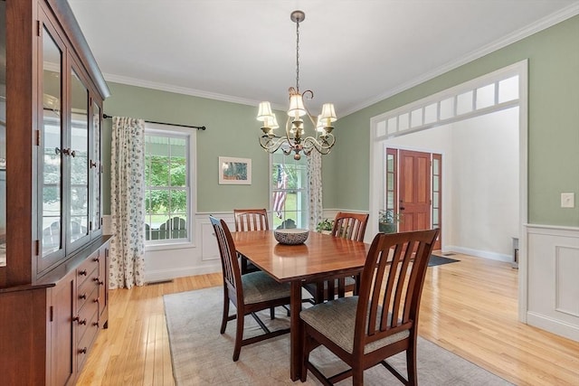 10 Londonderry Ln, Georgetown, MA 01833 - dining area featuring light wood finished floors, ornamental molding, a wainscoted wall, and a chandelier