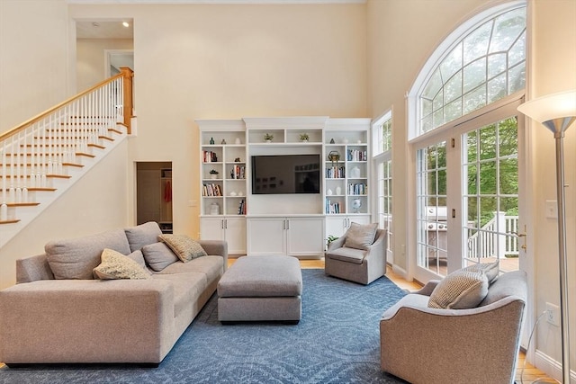 10 Londonderry Ln, Georgetown, MA 01833 - living area with a high ceiling, stairs, and wood finished floors