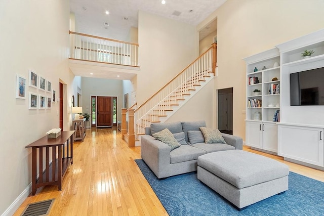 10 Londonderry Ln, Georgetown, MA 01833 - living area featuring a towering ceiling, light wood finished floors, and stairs