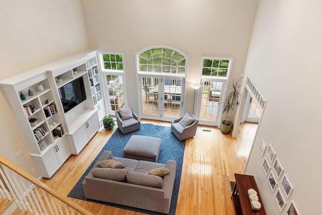 10 Londonderry Ln, Georgetown, MA 01833 - living room with a towering ceiling, french doors, and light wood finished floors