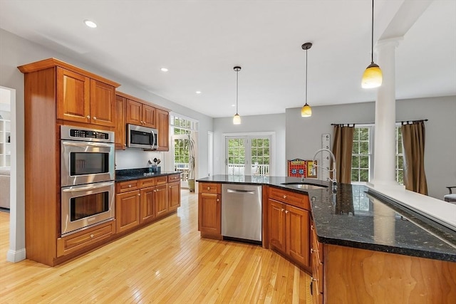 10 Londonderry Ln, Georgetown, MA 01833 - kitchen featuring stainless steel appliances, light wood-style floors, brown cabinetry, decorative light fixtures, and recessed lighting