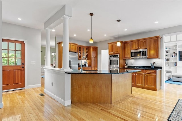 10 Londonderry Ln, Georgetown, MA 01833 - kitchen featuring stainless steel appliances, ornate columns, light wood-style flooring, brown cabinets, and recessed lighting