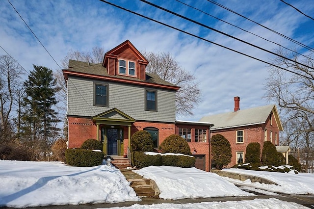 american foursquare style home featuring brick siding