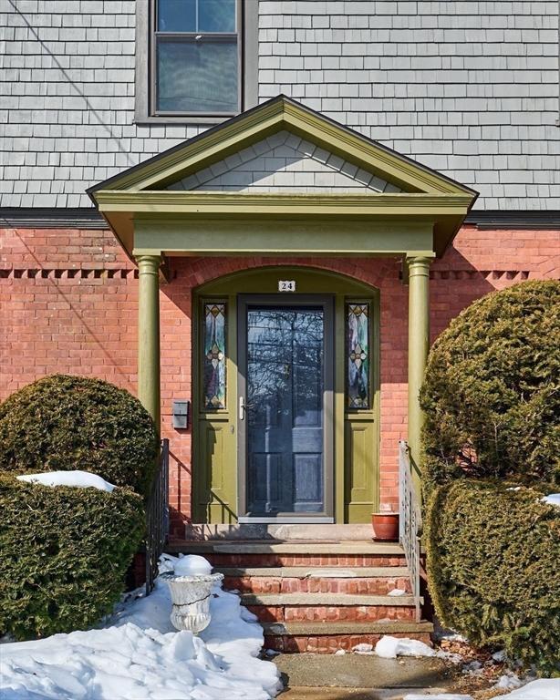 entrance to property featuring brick siding