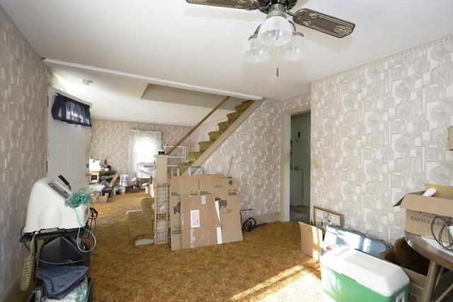 interior space featuring carpet flooring and ceiling fan