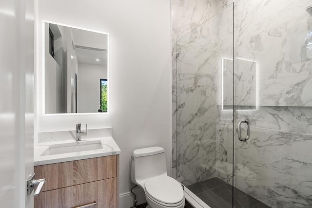 bathroom featuring toilet, vanity, and a marble finish shower