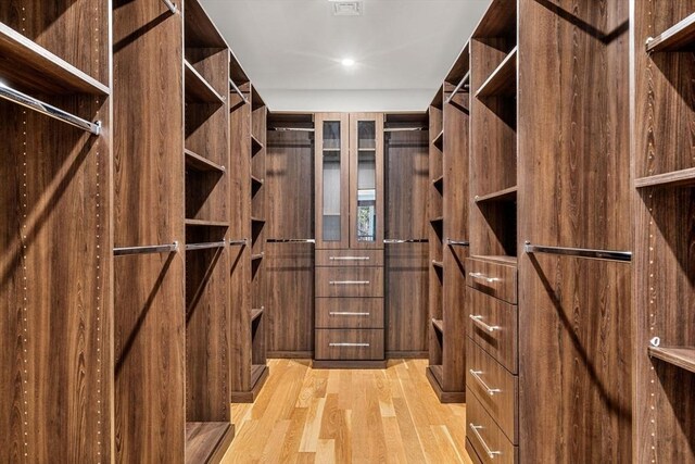 spacious closet featuring light wood finished floors