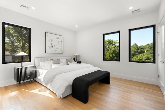 bedroom with recessed lighting, baseboards, visible vents, and light wood finished floors