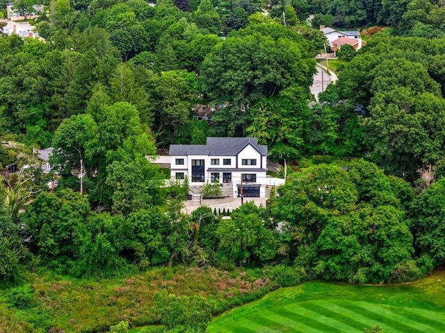 aerial view featuring a wooded view