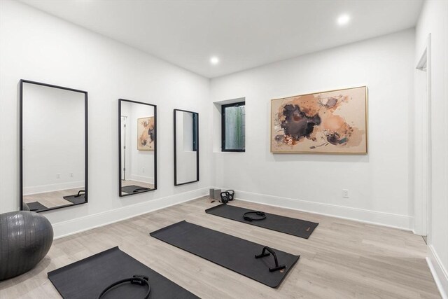 workout area with recessed lighting, baseboards, and wood finished floors