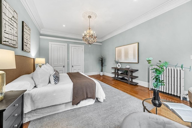 318 Commonwealth Ave Unit 3, Boston, MA 02115 - bedroom featuring radiator, wood finished floors, a chandelier, and crown molding