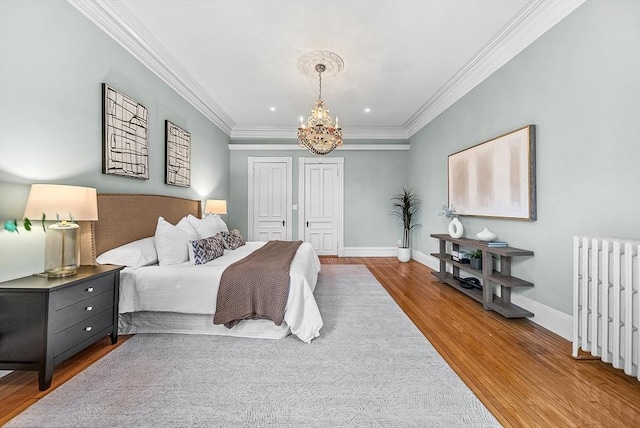 318 Commonwealth Ave Unit 3, Boston, MA 02115 - bedroom featuring radiator heating unit, wood finished floors, a chandelier, crown molding, and recessed lighting