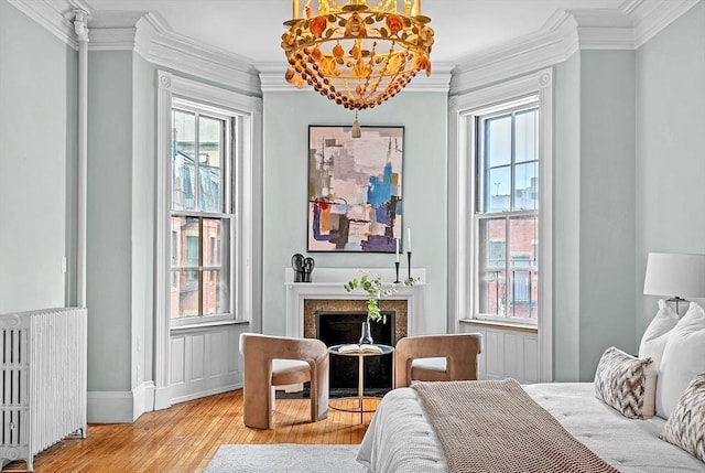 318 Commonwealth Ave Unit 3, Boston, MA 02115 - bedroom with radiator, wood-type flooring, multiple windows, and crown molding