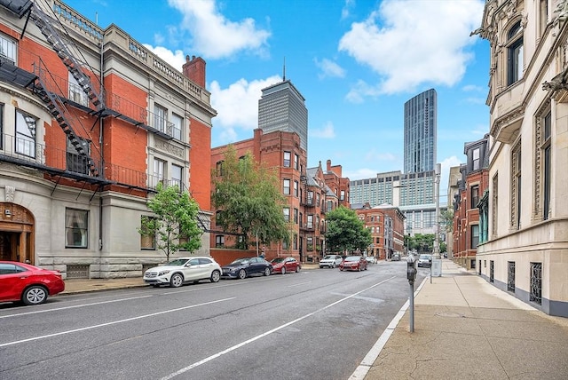 318 Commonwealth Ave Unit 3, Boston, MA 02115 - view of asphalt road featuring sidewalks, a city view, street lighting, and curbs